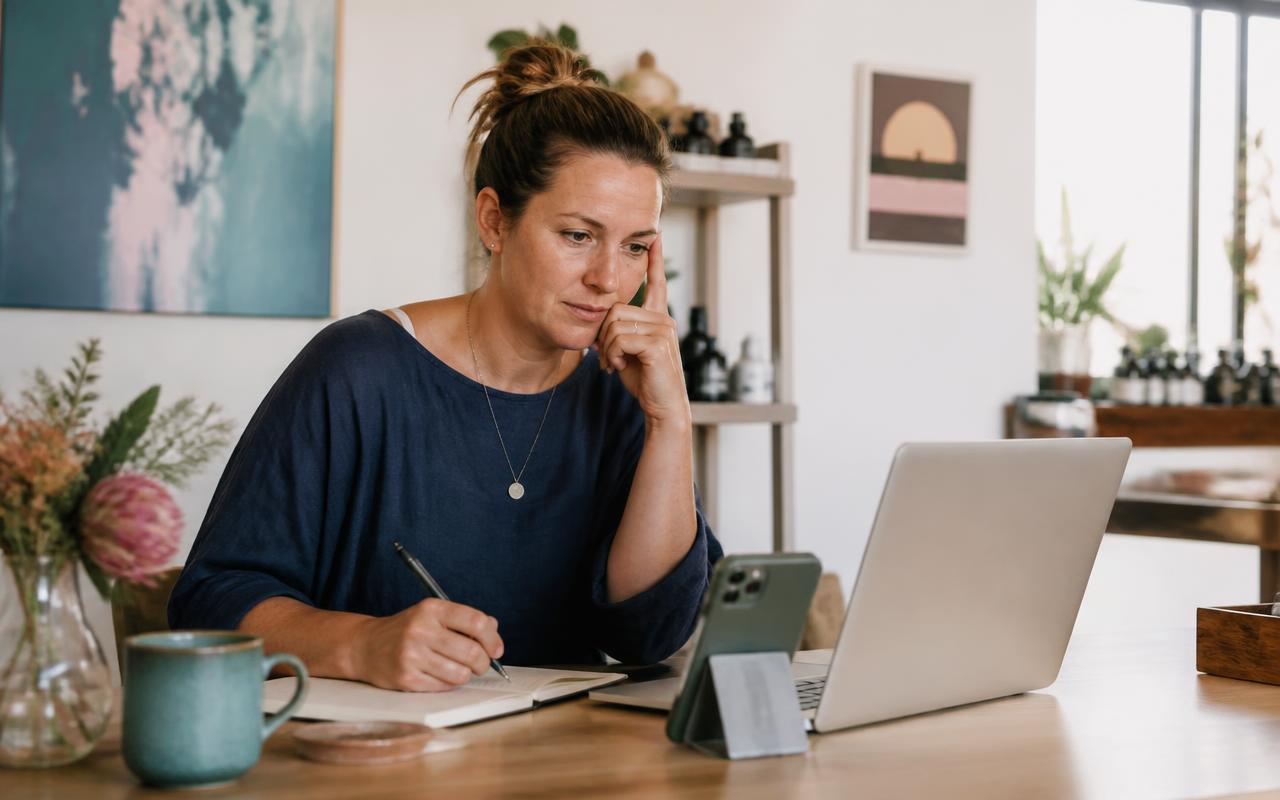 A wellness business owner guessing at prices in a notebook without a pricing calculator